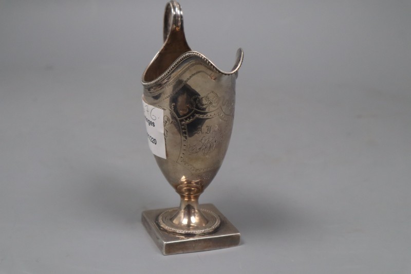 A George III engraved silver helmet shaped cream jug, Peter & Ann Bateman, London, 1793, 14.3cm, 3.5 oz.